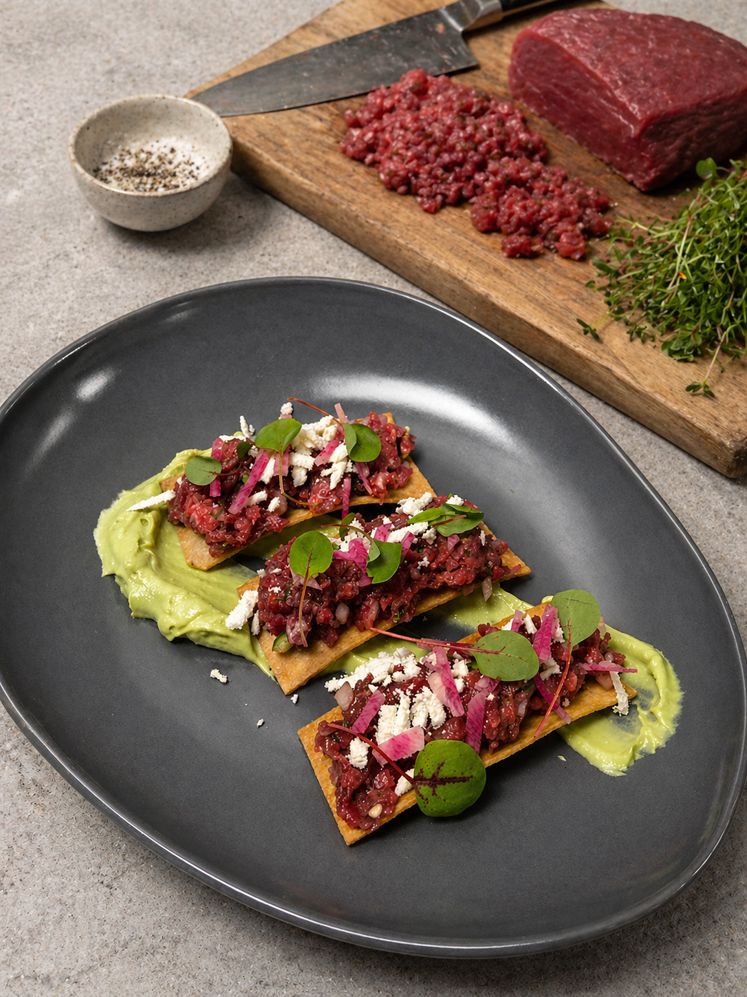 Luna Mesa Catering beef tartare on crispy flatbread with avocado mousse and microgreens