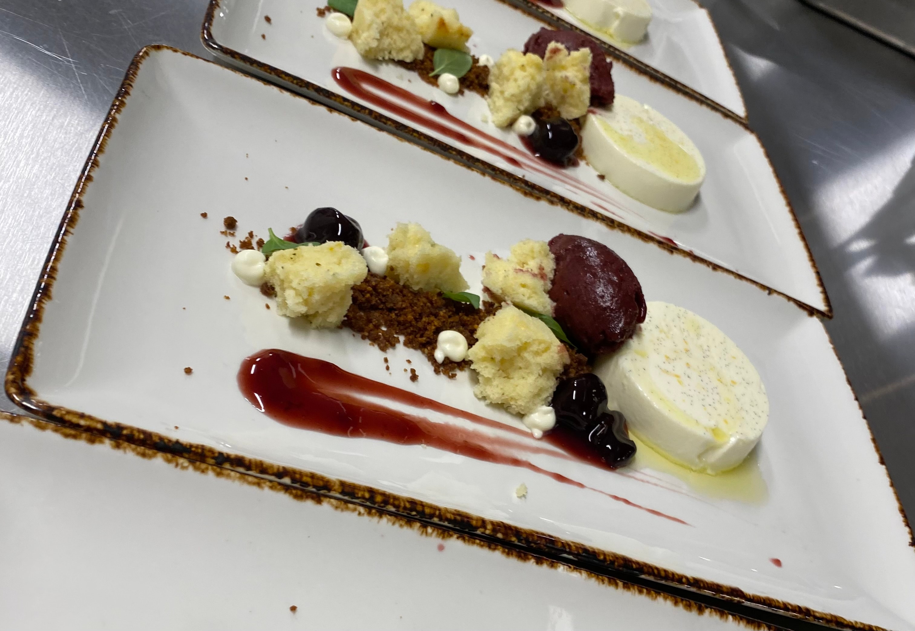 Luna Mesa Catering vanilla panna cotta with blueberry sorbet, lemon cake crumble, cherry compote and berry coulis